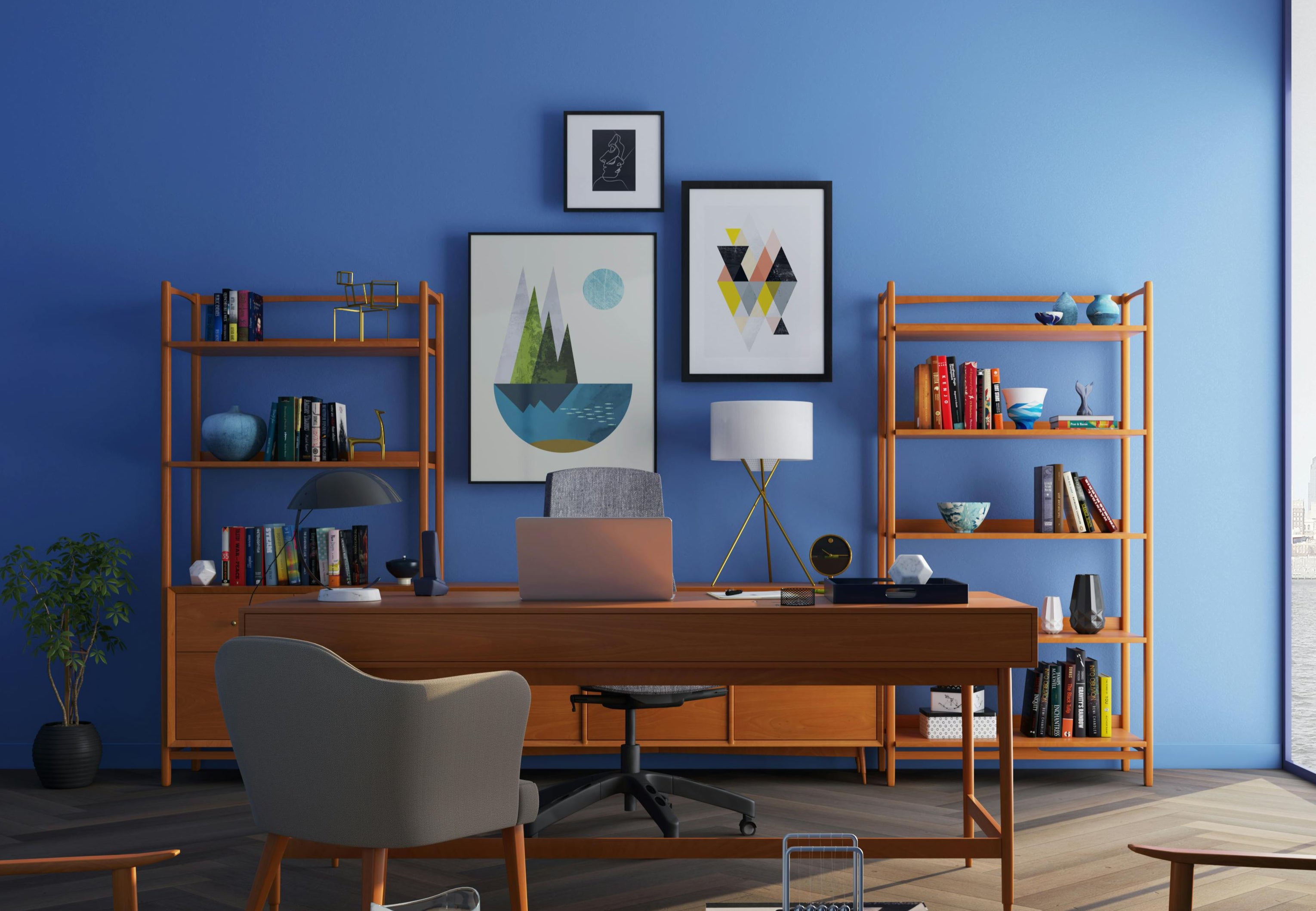 a home office with two shelving units with bright blue walls